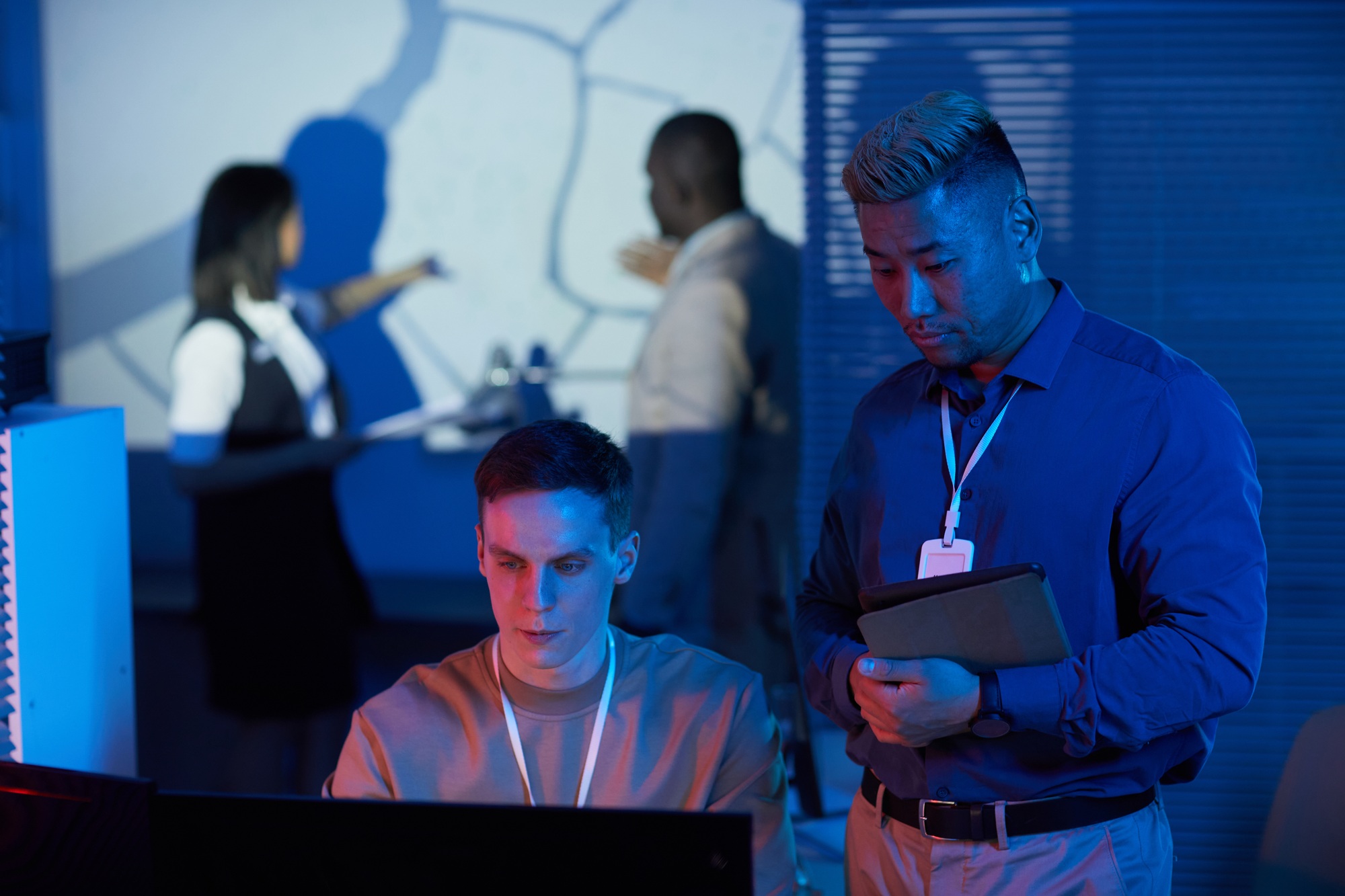 Two people working in mission control center